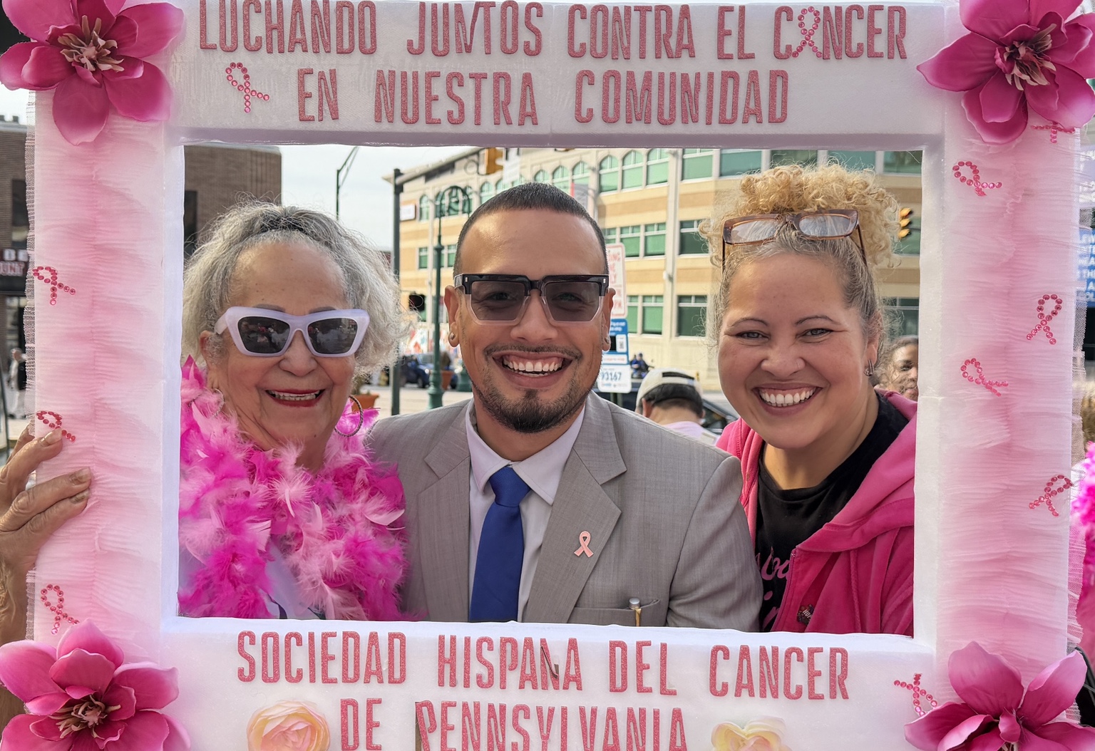 Jaime with community members holding a Sociedad Hispana del Cáncer de Pennsylvania photo frame